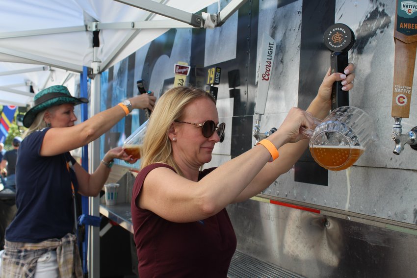 Golden Civic Foundation board member Melissa Anderson, right, and foundation staff member Traci Lacey pour beer during the inaugural Wild West Oktoberfest Sept. 24 in downtown Golden. The nonprofit received proceeds from the event, which was organized by YoColorado.